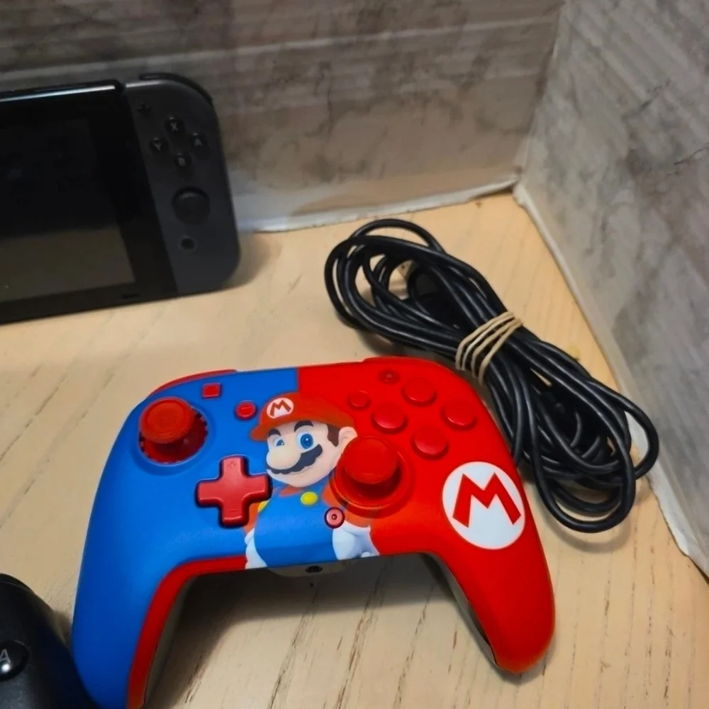 Nintendo Switch with Black Pro Controller and Blue Red Wired Controller
